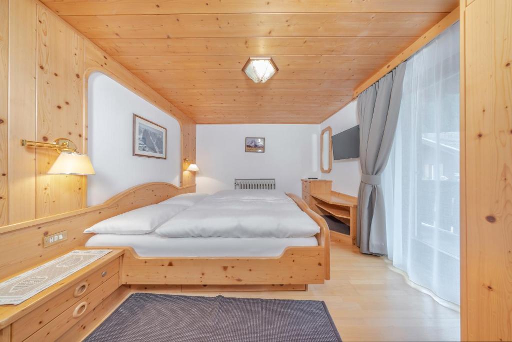 Postel nebo postele na pokoji v ubytování Garni Tramans