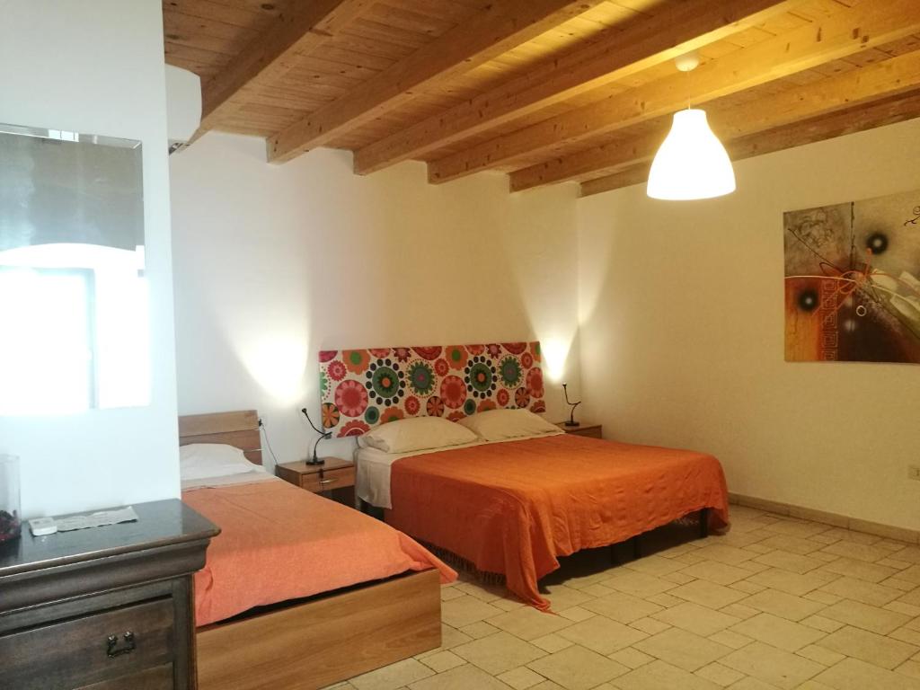 Postel nebo postele na pokoji v ubytování Corte Del Borgo Antico