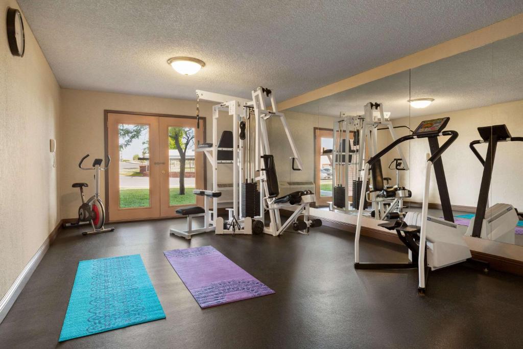 a gym with treadmills and machines in a room at Baymont by Wyndham Cortez in Cortez