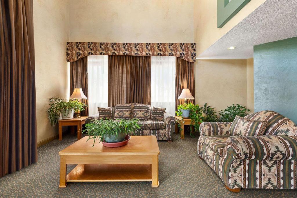 a living room with a couch and a table at Baymont by Wyndham Cortez in Cortez