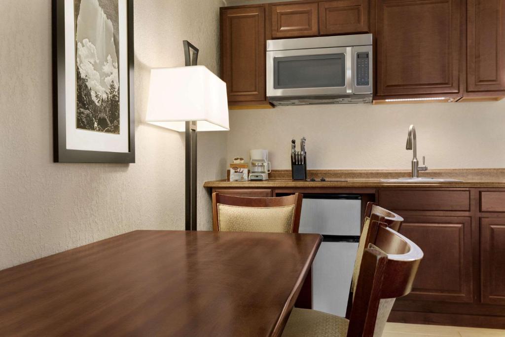 a kitchen with a table and a microwave at Baymont by Wyndham Cortez in Cortez