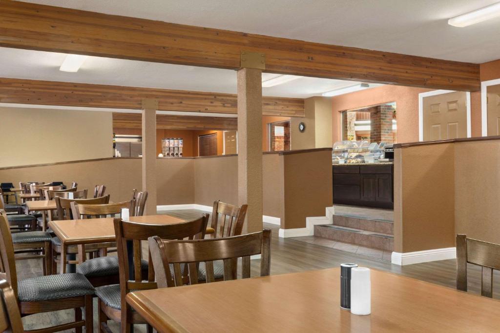 a restaurant with tables and chairs and a bar at Baymont by Wyndham Cortez in Cortez