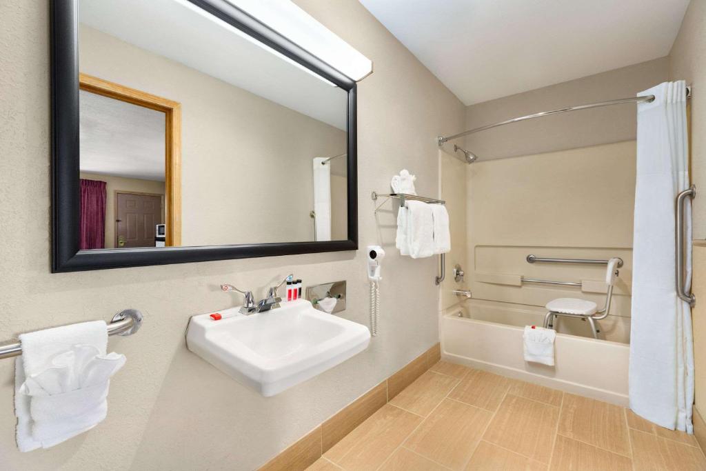 a bathroom with a sink and a mirror at Baymont by Wyndham Cortez in Cortez