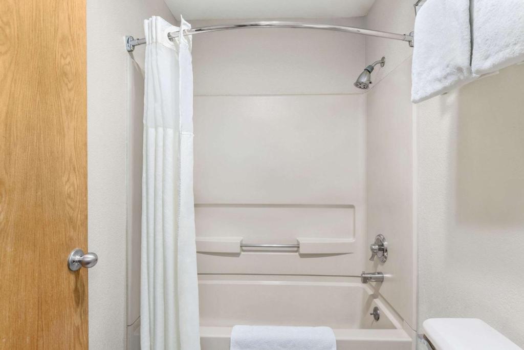 a bathroom with a shower curtain and a toilet at Baymont by Wyndham Cortez in Cortez