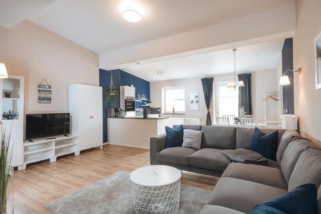 a living room with a couch and a table at Apartments Am Erdbeerhof in Rövershagen