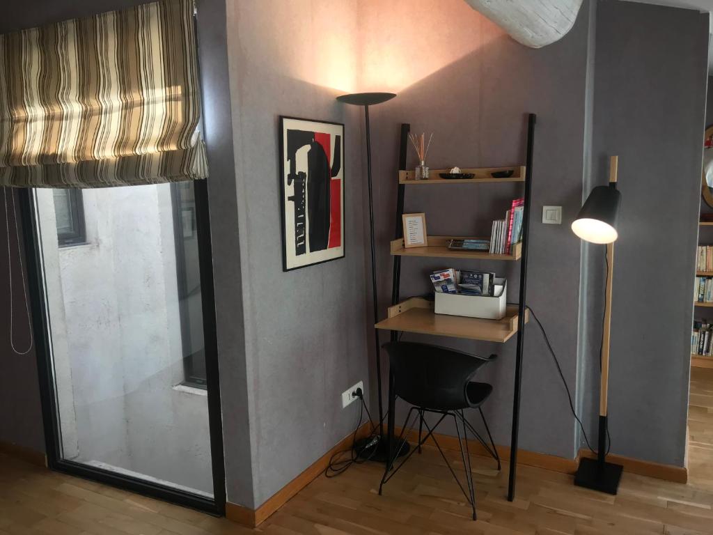 a room with a desk and a lamp and a window at Les Chambres de l'Abbaye in Marseille