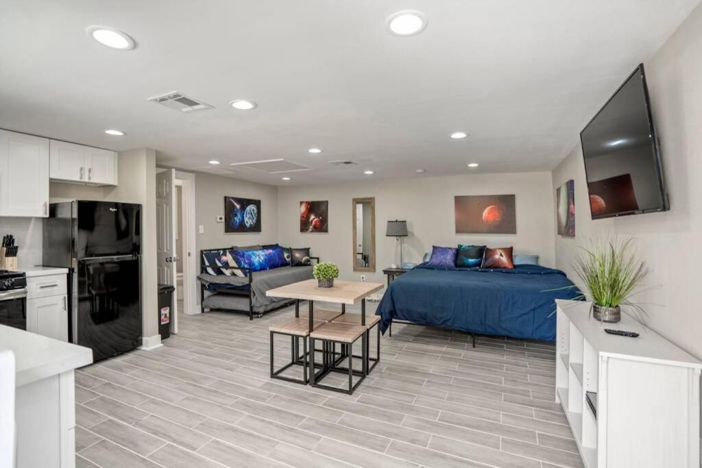 a living room with a bed and a kitchen at Cosmic Studio at North Downtown in Houston