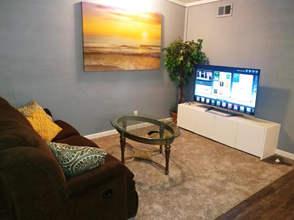 a living room with a couch and a large television at Dolan Springs, Grand Canyon Skywalk in Dolan Springs
