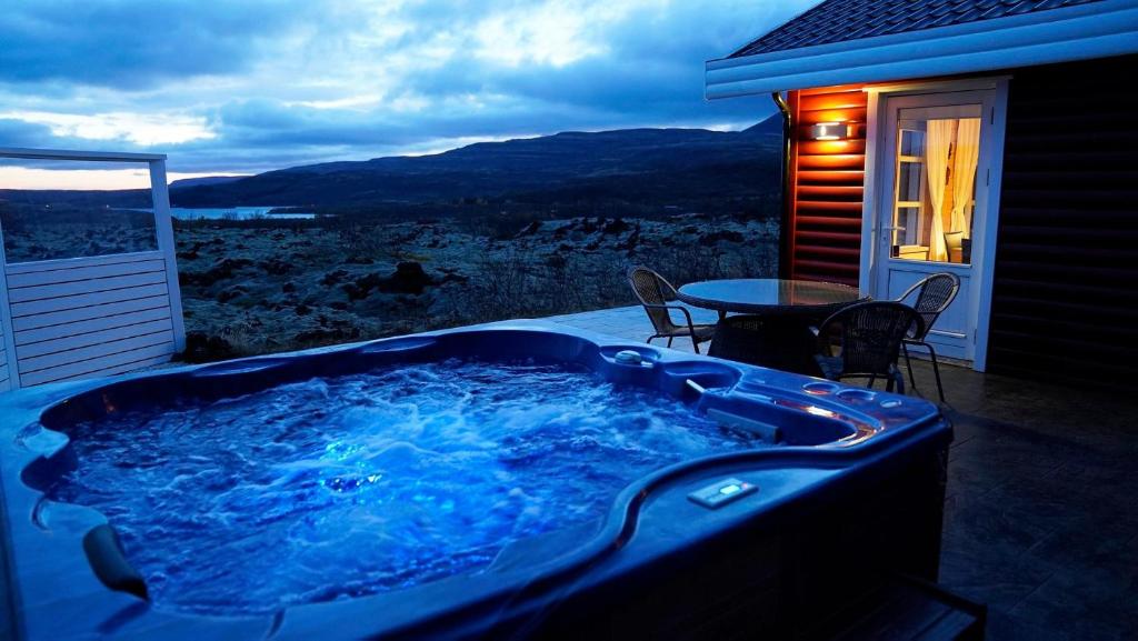a hot tub on the patio of a house at House in lava in Borgarnes