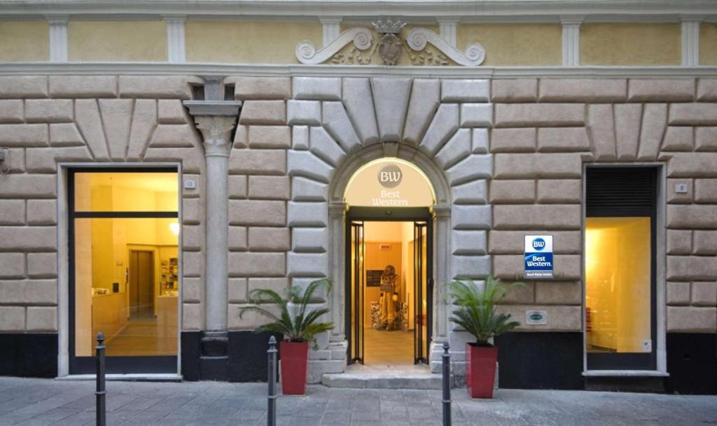 a building with two doors and two potted plants at Best Western Porto Antico in Genoa