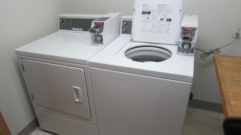 a white washer and dryer in a room at Super 8 by Wyndham Revelstoke BC in Revelstoke