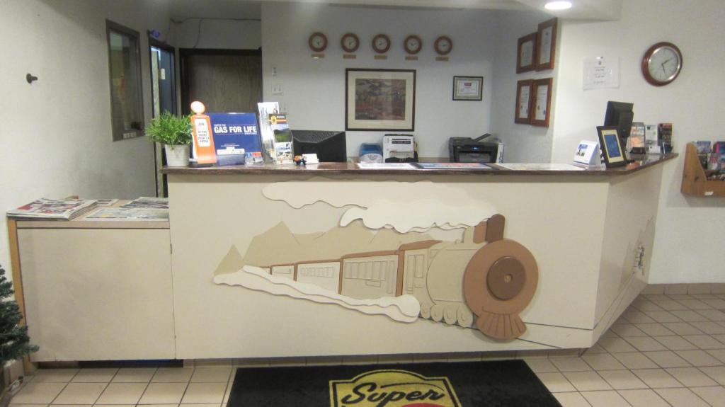 a counter in a store with a train painted on it at Super 8 by Wyndham Revelstoke BC in Revelstoke