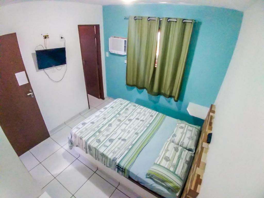 Ein Bett oder Betten in einem Zimmer der Unterkunft Apartamento Mobiliado Mozart