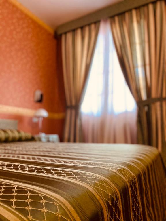 Postel nebo postele na pokoji v ubytování Hotel Daniel