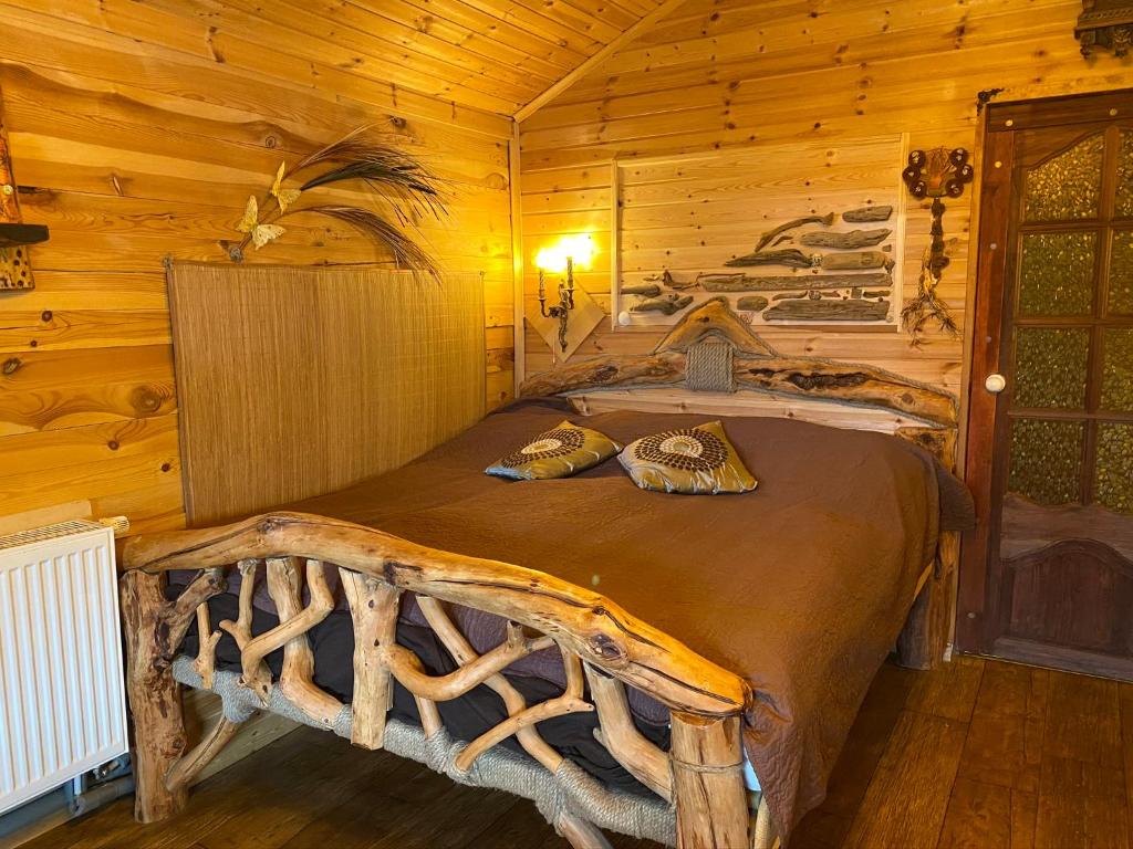 a bedroom with a bed in a log cabin at Guest House Melon in Jūrmala