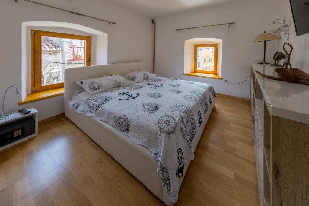 a bedroom with a bed and a kitchen with windows at Krka Waterfalls in Skradin