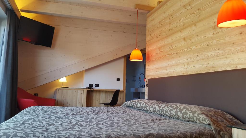 Postel nebo postele na pokoji v ubytování Hotel Alpino