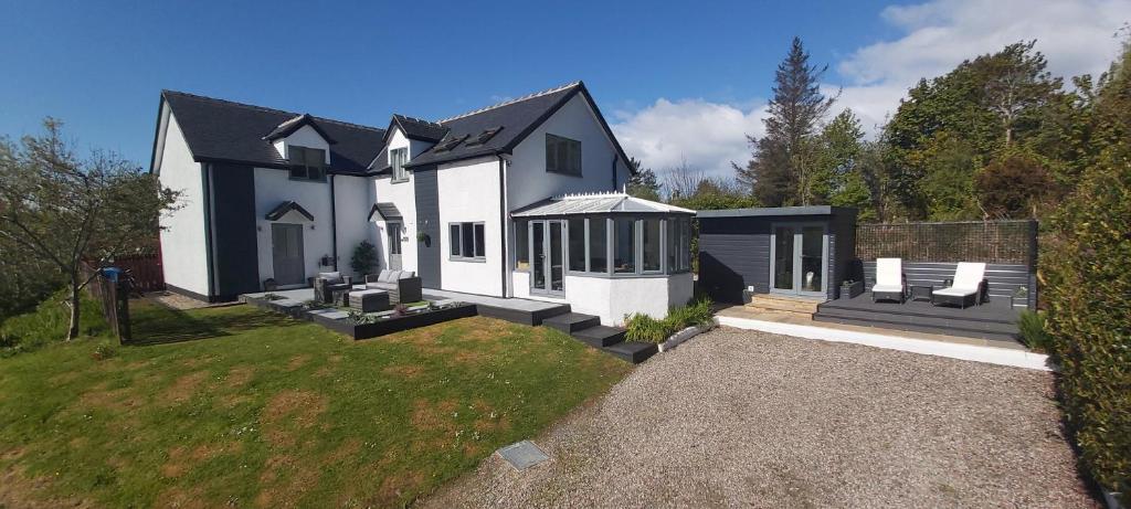 a large white house with a yard at Brae Hoose in Arisaig