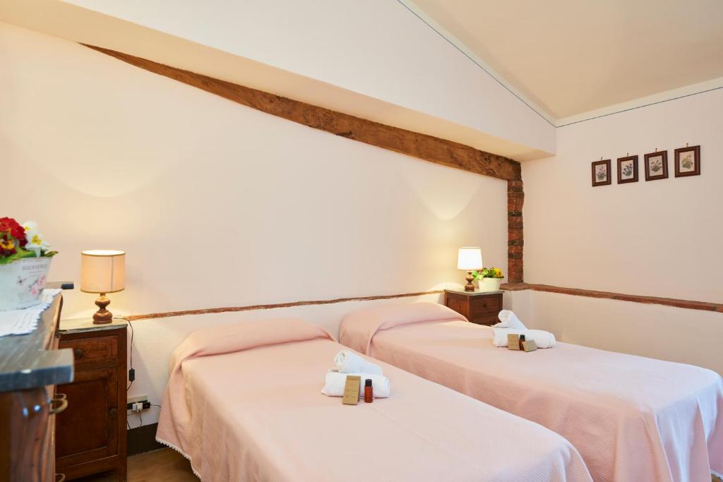 Postel nebo postele na pokoji v ubytování Agriturismo Pometti - Fattoria La Selva