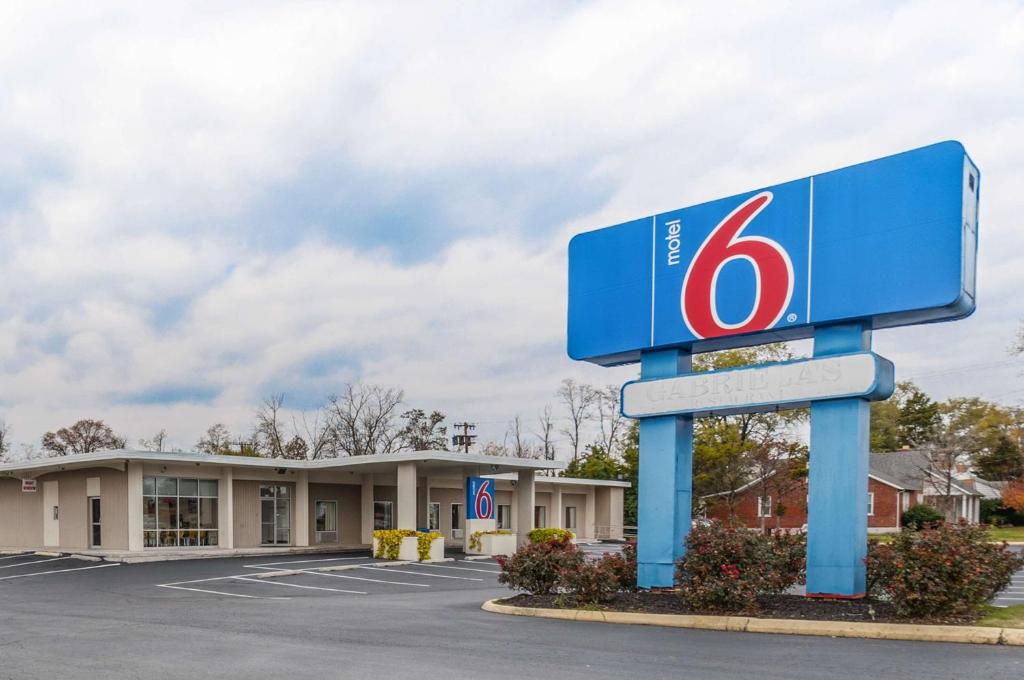 a gas station with a sign in a parking lot at Motel6 Winchester, VA in Winchester