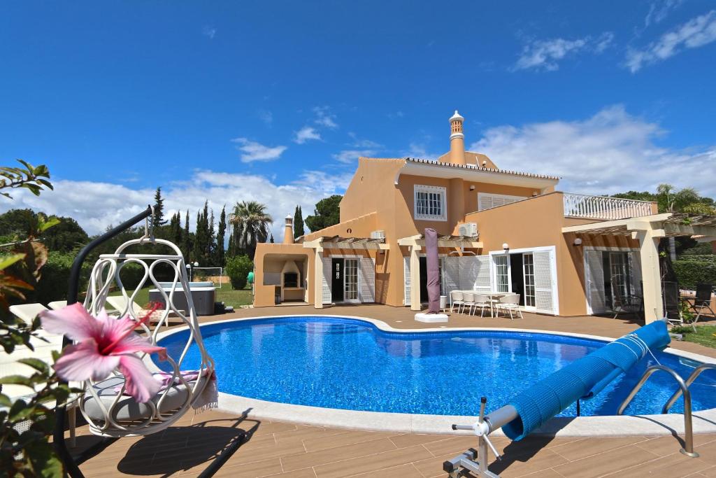a villa with a swimming pool and a house at Villa Nataliza 172- Clever Details in Vilamoura