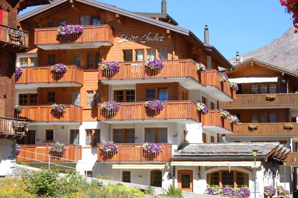 a large building with flower boxes on its balconies at Apartment Swiss Chalet in Saas-Fee