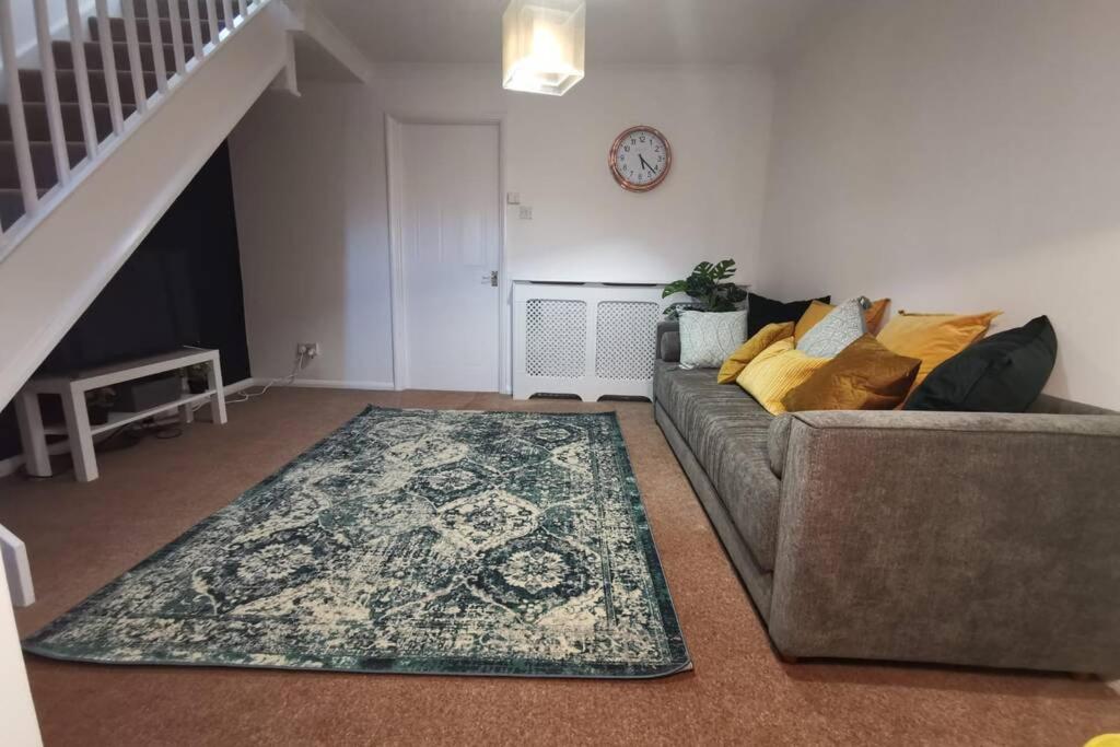 a living room with a couch and a rug at Cosy up in Palmers Leaze in Bristol