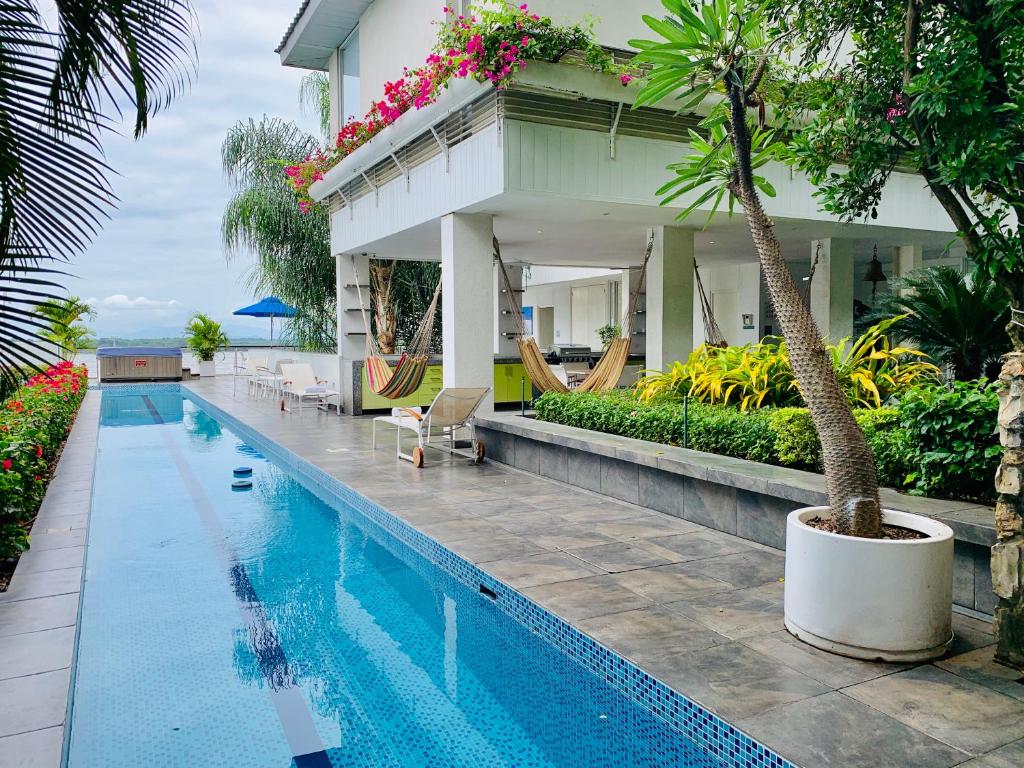 a swimming pool in front of a house with a resort at Casa Las Peñas Siglo XXI B&B in Guayaquil