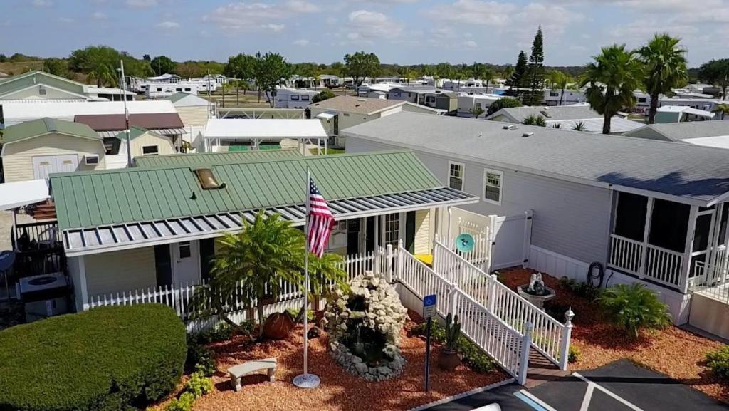 an aerial view of a white house with a green roof at Woody's RV Resort LLC in Sebring