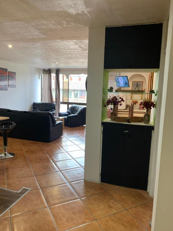 a living room with a couch and a table at F2 Tapu in Papeete
