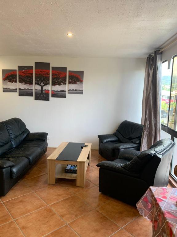 a living room with a couch and a table at F2 Tapu in Papeete