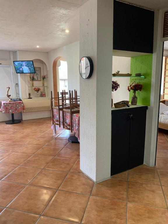a living room with a tile floor and a kitchen at F2 Tapu in Papeete