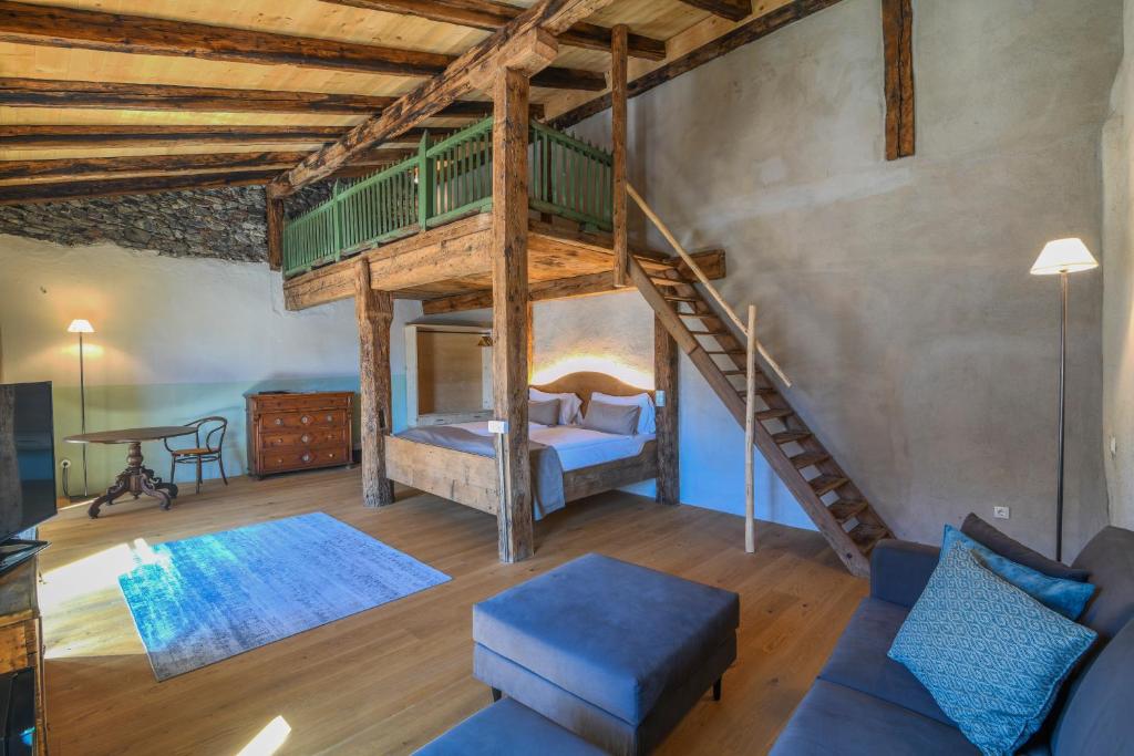 ein Wohnzimmer mit einem Hochbett und einem Sofa in der Unterkunft rössl bianco b&b&b in Meran