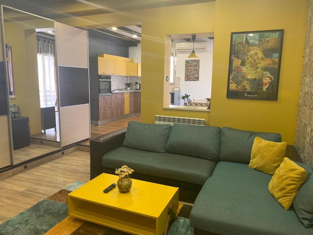 a living room with a couch and a table at Trakia Street Apartment in Plovdiv