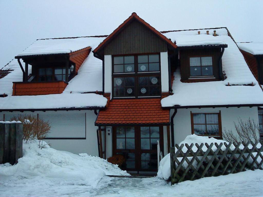 a house with snow on top of it at Ferienwohnung Glück Auf in Altenau