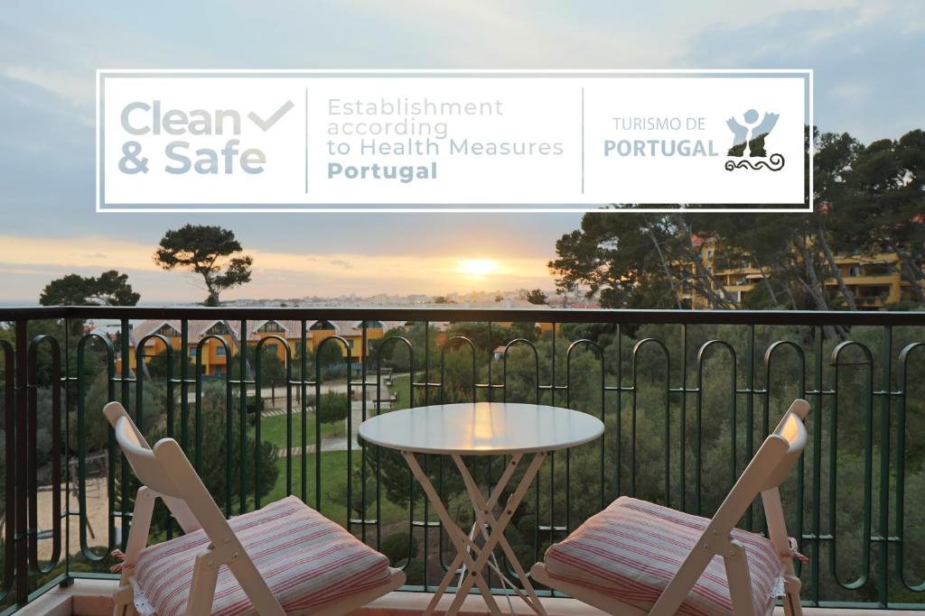a balcony with a table and two chairs and a table at Cascais Estoril Apartment 400 m from Beach in Estoril