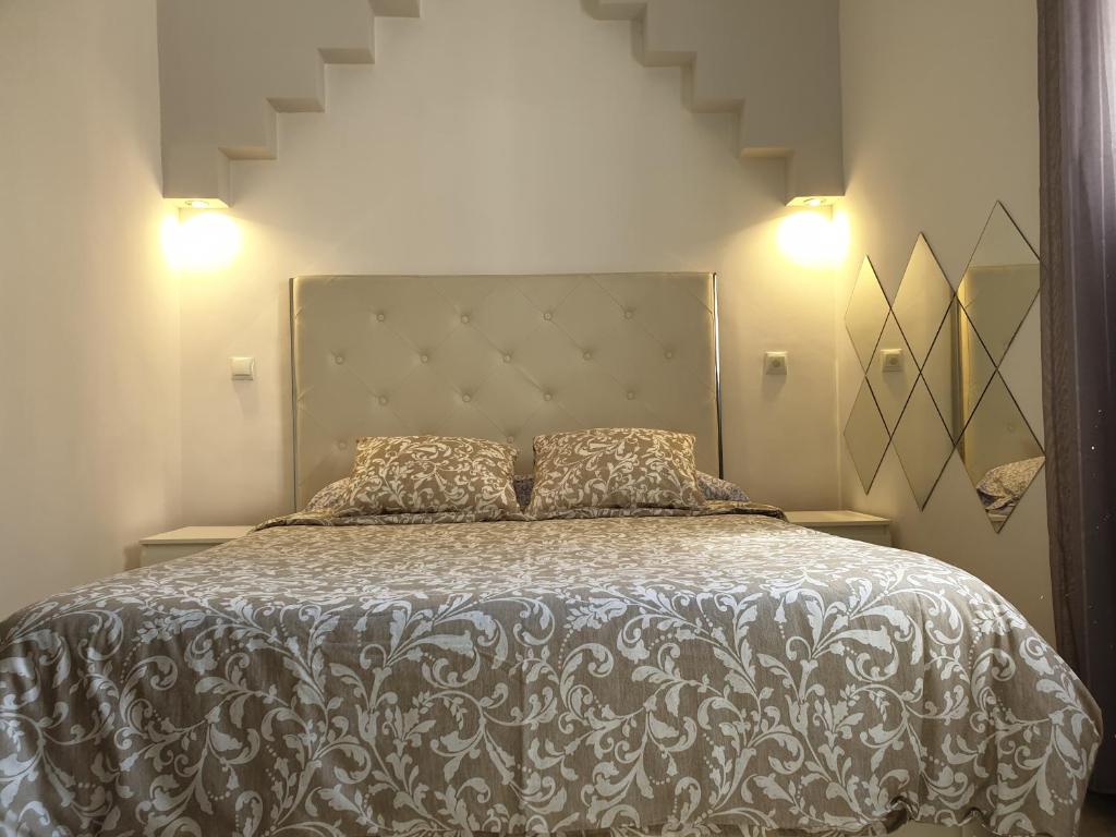 a bedroom with a large bed with two pillows at Bonito Apto Cinco Torres Plaza Castilla in Madrid