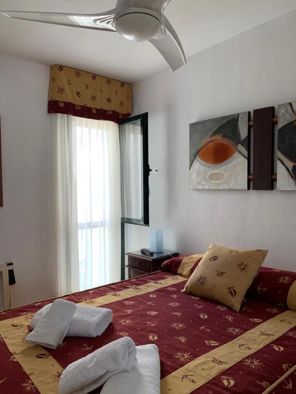 a bedroom with a large bed with two towels on it at Apartamento Zahara in Zahara de los Atunes