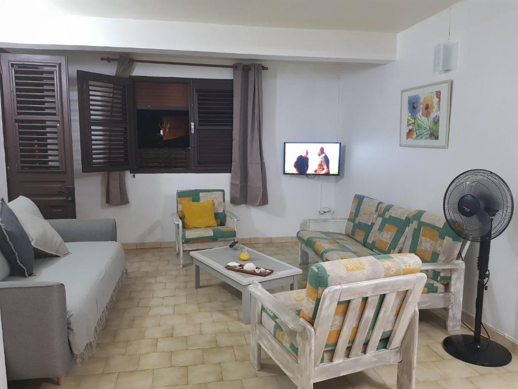 a living room with a couch and a table at ROY'AL BEACH HOLIDAYS in Sainte-Luce