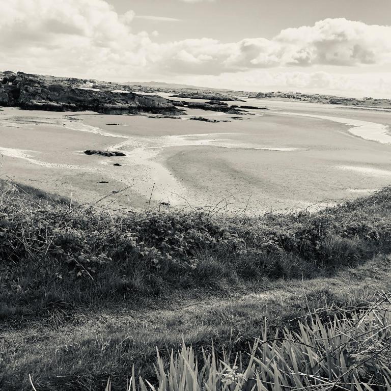 a black and white photo of a beach at Village Way Apartments in Kincasslagh