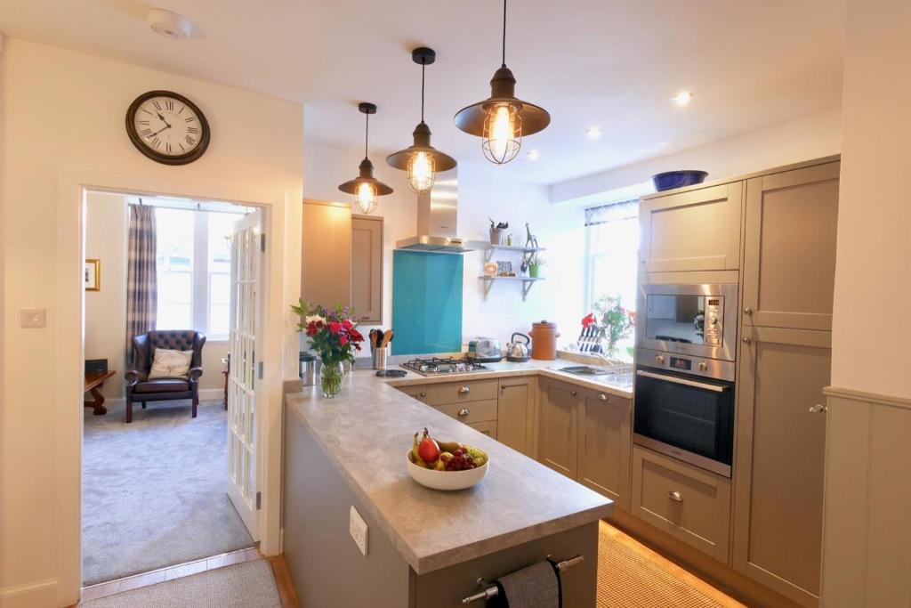 a kitchen with a bowl of fruit on a counter at Providence Cottage in Kirkcudbright