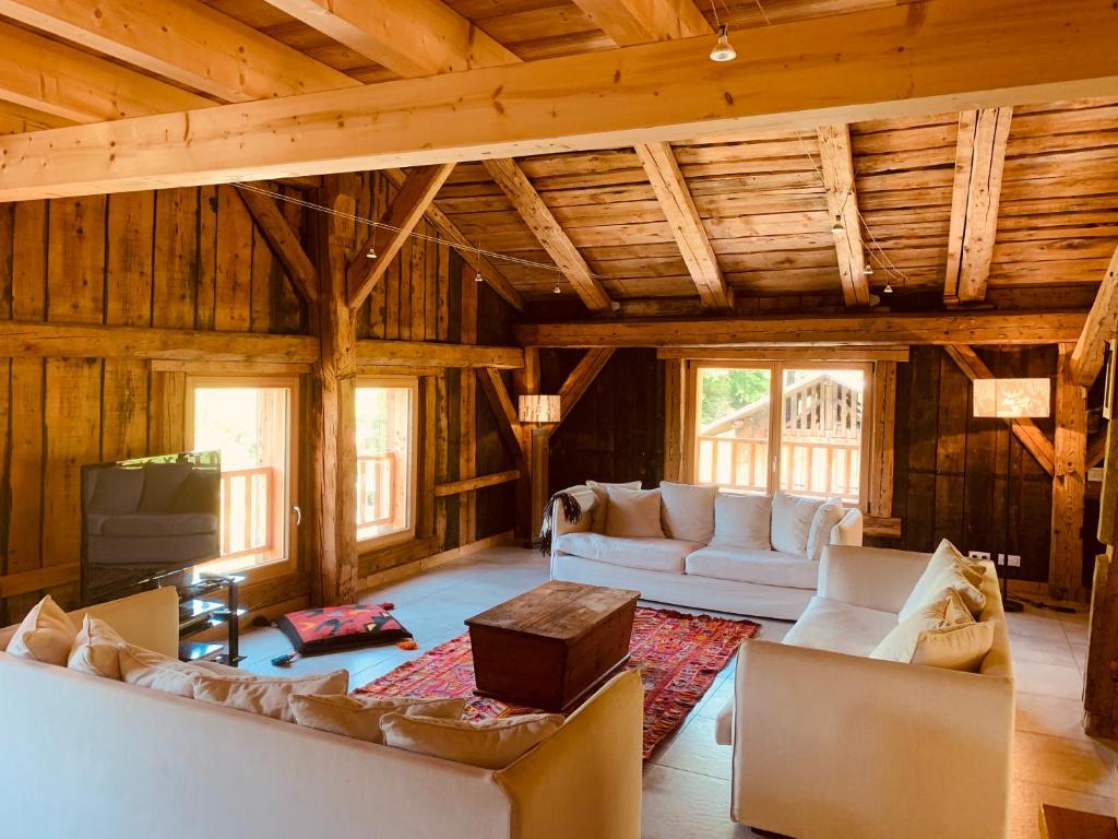 een woonkamer met een bank en een tafel bij Le Chalet dans les Etoiles in Samoëns