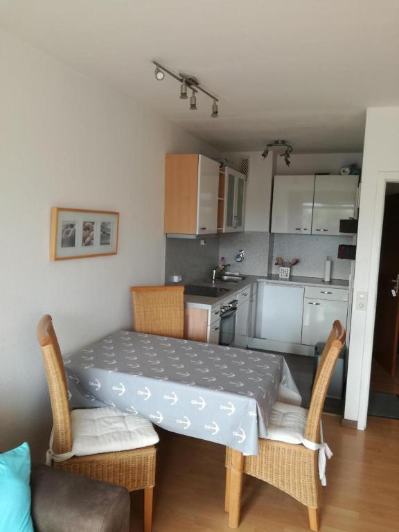 a small kitchen with a table and chairs in a room at Strandhotel Wohnung 24 in Dahme