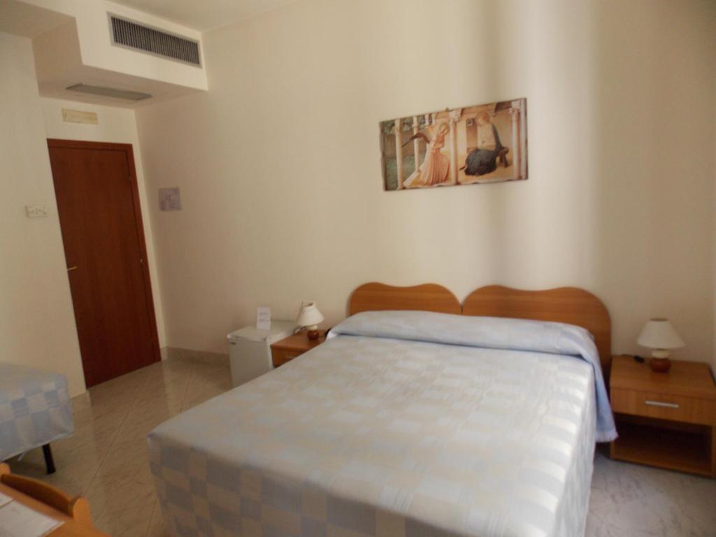 Postel nebo postele na pokoji v ubytování Albergo Roma