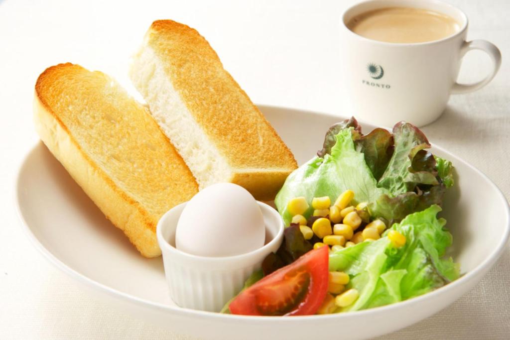 a plate of food with a salad and a sandwich and a cup of coffee at Sotetsu Fresa Inn Tokyo-Toyocho in Tokyo