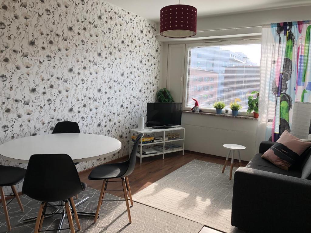 a living room with a white table and chairs at Feels like Arctic City in Rovaniemi