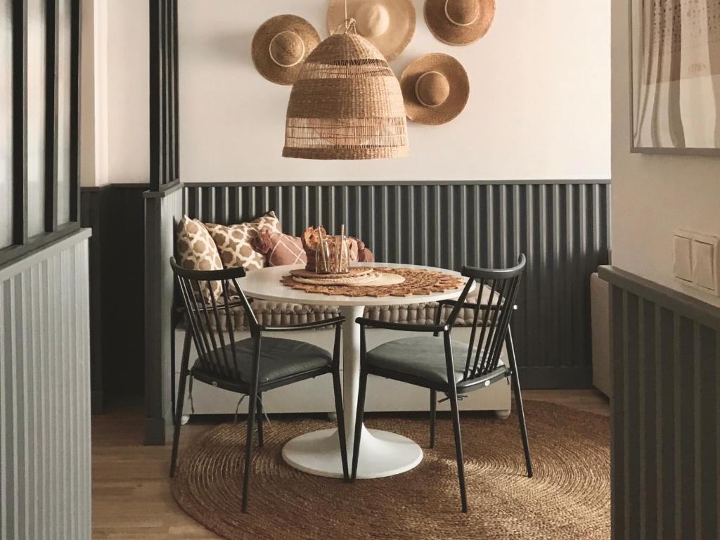 a dining room table with two chairs and a table with a basket at Central Point by Zoom Apartments in Bratislava