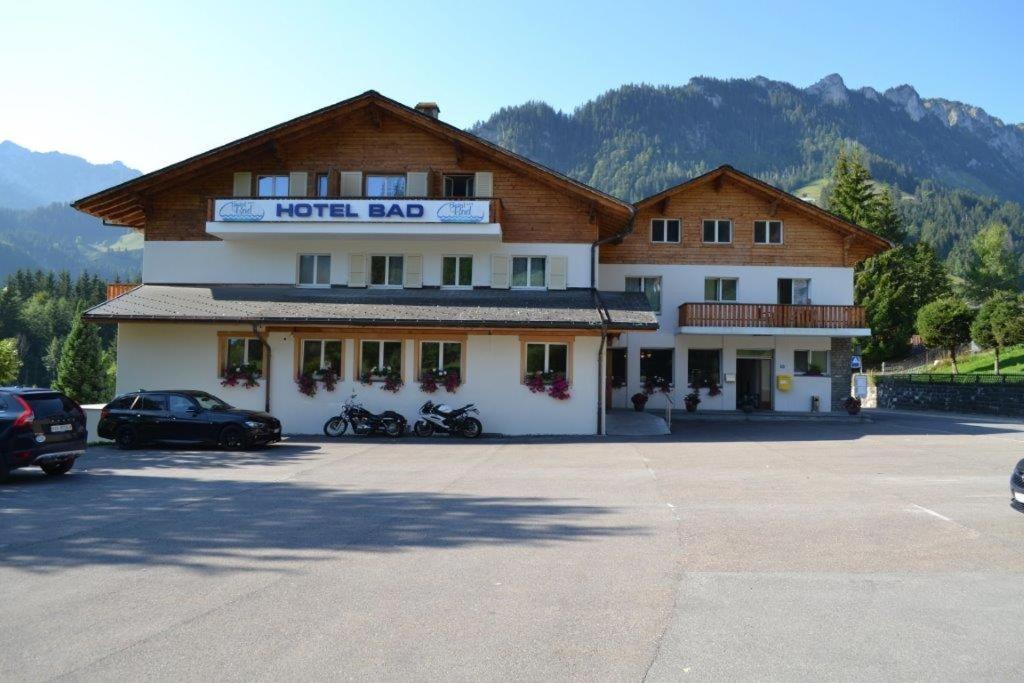 a hotel building with motorcycles parked in a parking lot at Hotel Bad Schwarzsee in Bad-Schwarzsee