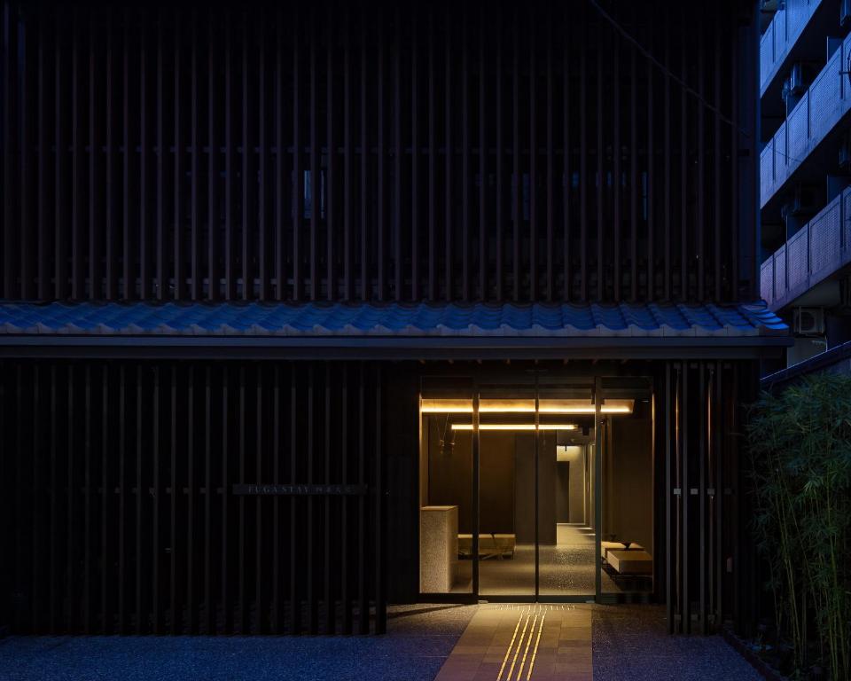 an entrance to a building with a blue awning at FUGASTAY Shijo Omiya in Kyoto