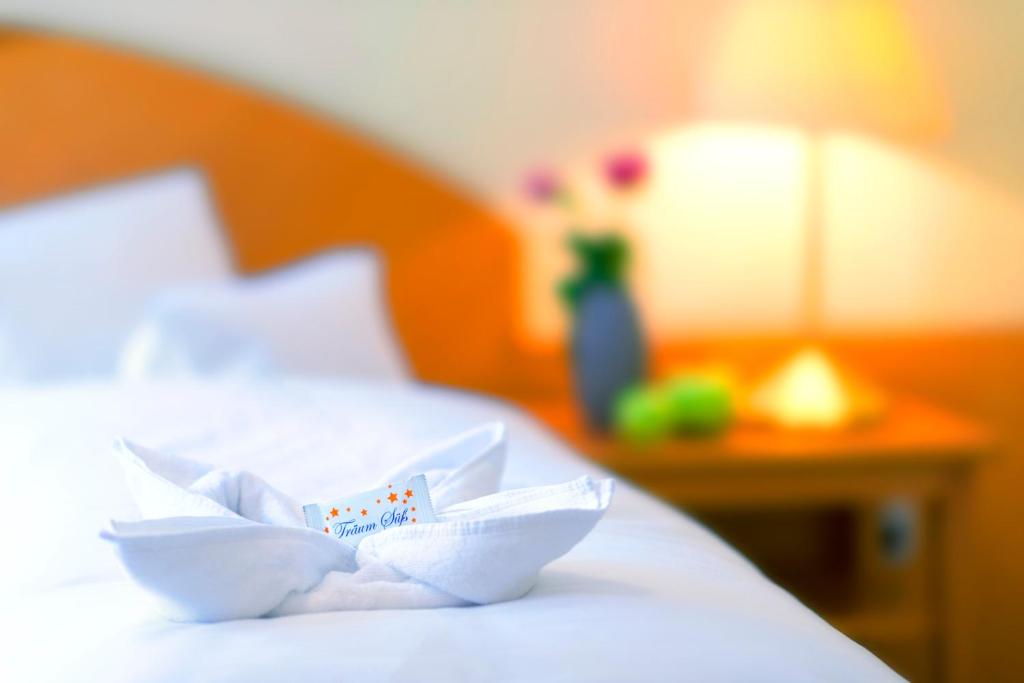 Postel nebo postele na pokoji v ubytování Hotel Stoiser Graz